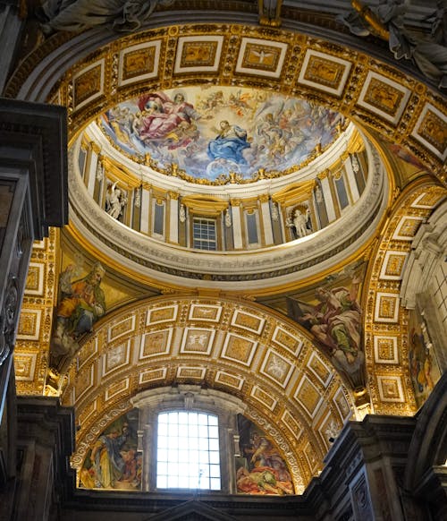 The ceiling of a cathedral with paintings on it