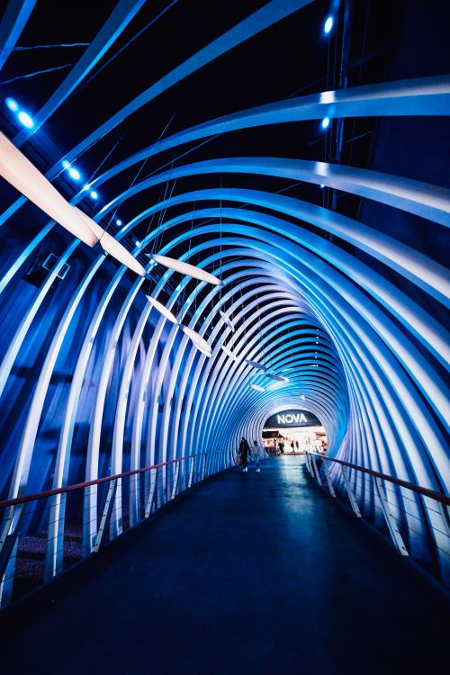 Free Explore a modern, blue-lit pedestrian tunnel in Leipzig, Germany's Nova Eventis mall. Stock Photo