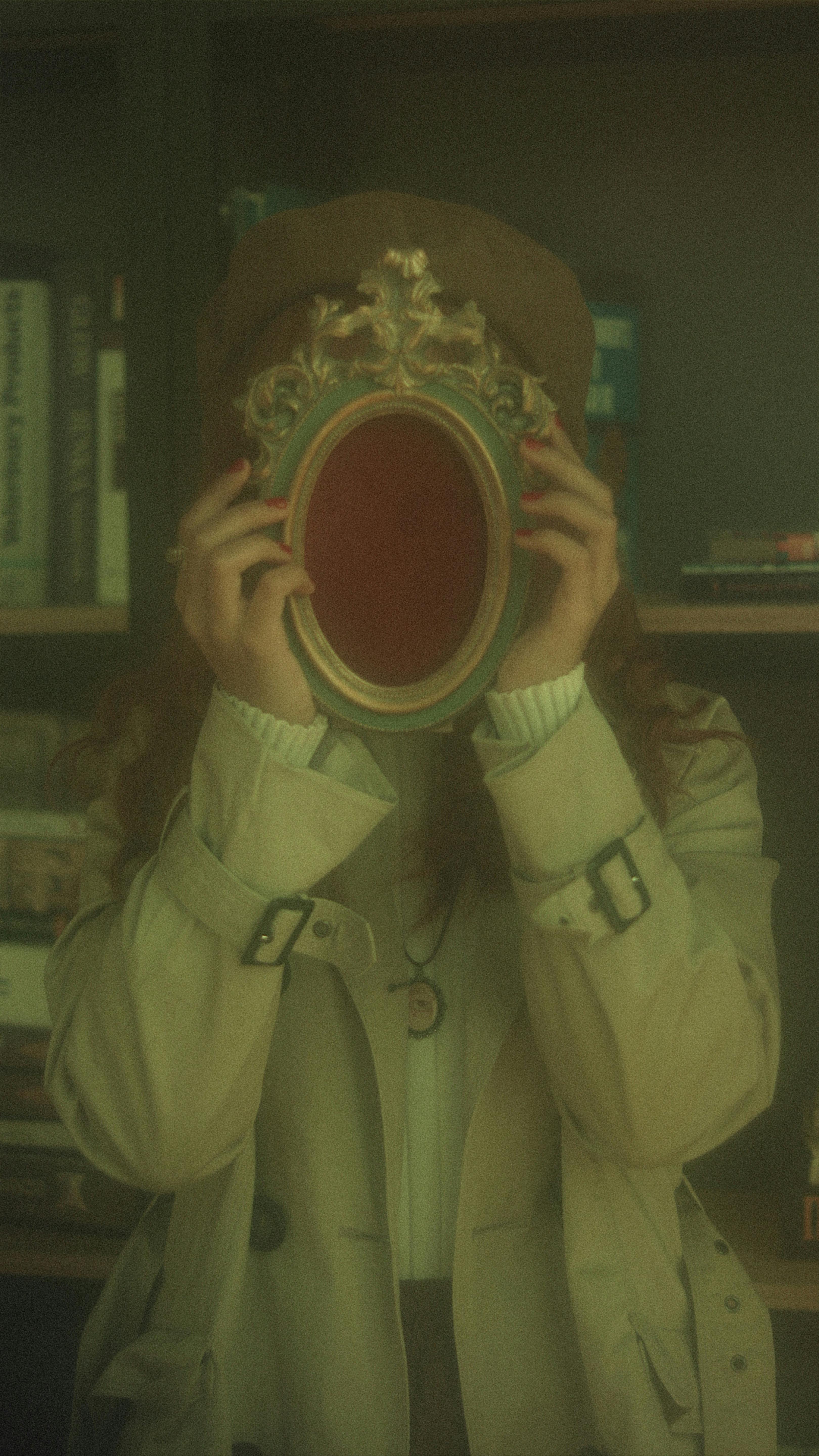 An enigmatic portrait of a woman holding an ornate antique mirror, blending style and intrigue.
