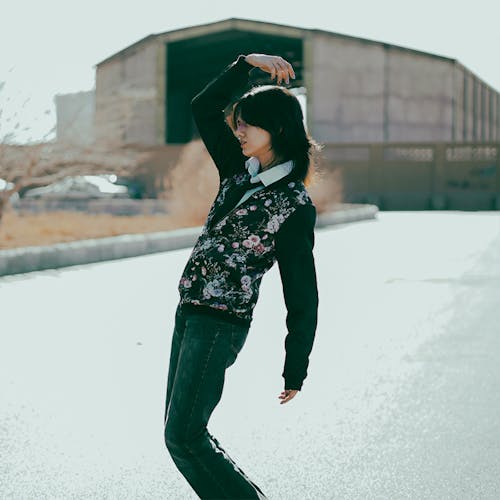 Woman with Arm Raised on Road