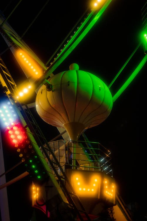 A ferris wheel with lights on it at night