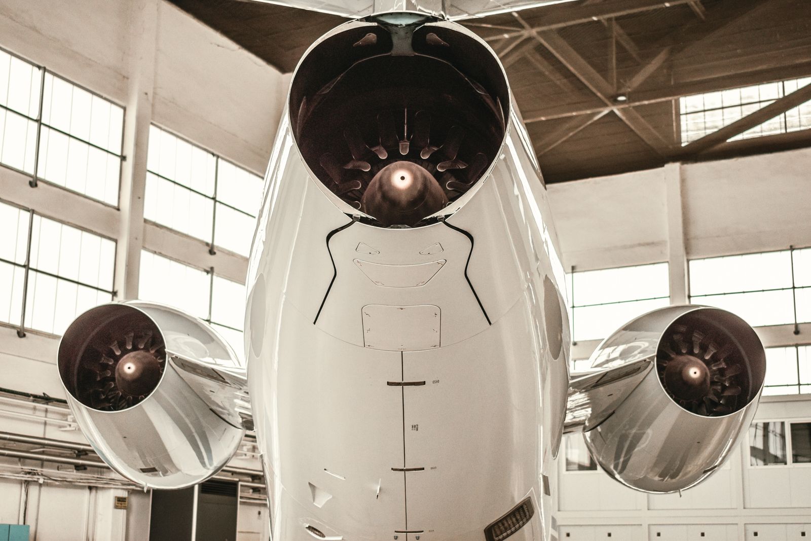 Close-up of aircraft jet engines displayed inside a hangar