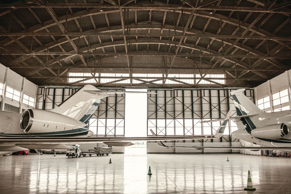 Private jets parked inside a hangar