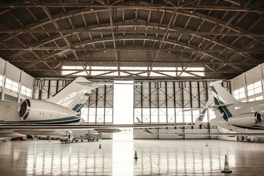 Private jets parked inside a large hangar in Paris, offering a glimpse into aviation luxury.