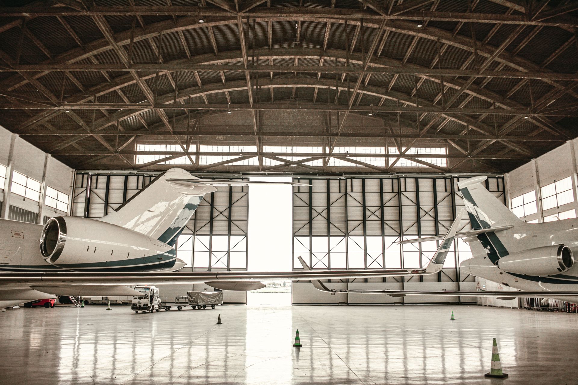 Pristine private jets inside a modern hangar