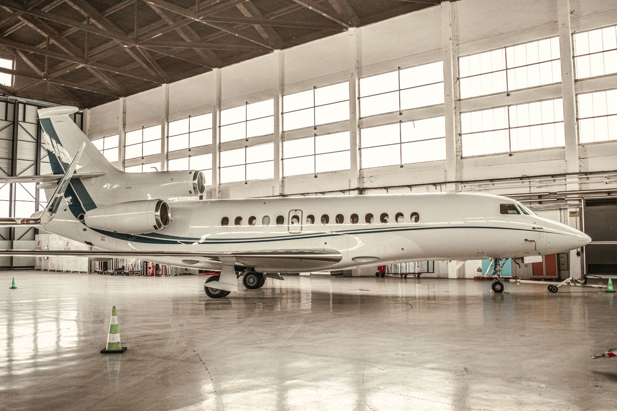Luxurious private jet parked inside a well-lit hangar in Paris
