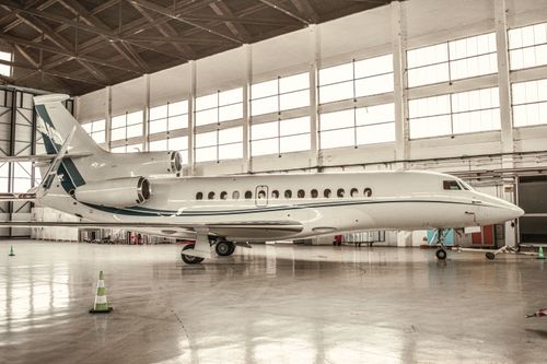 Free Luxurious private jet parked inside a well-lit hangar in Paris, France. Stock Photo
