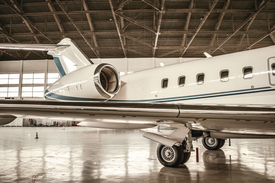 Aircraft parked inside a large maintenance hangar