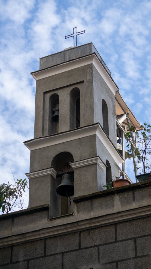A bell tower with a cross on top