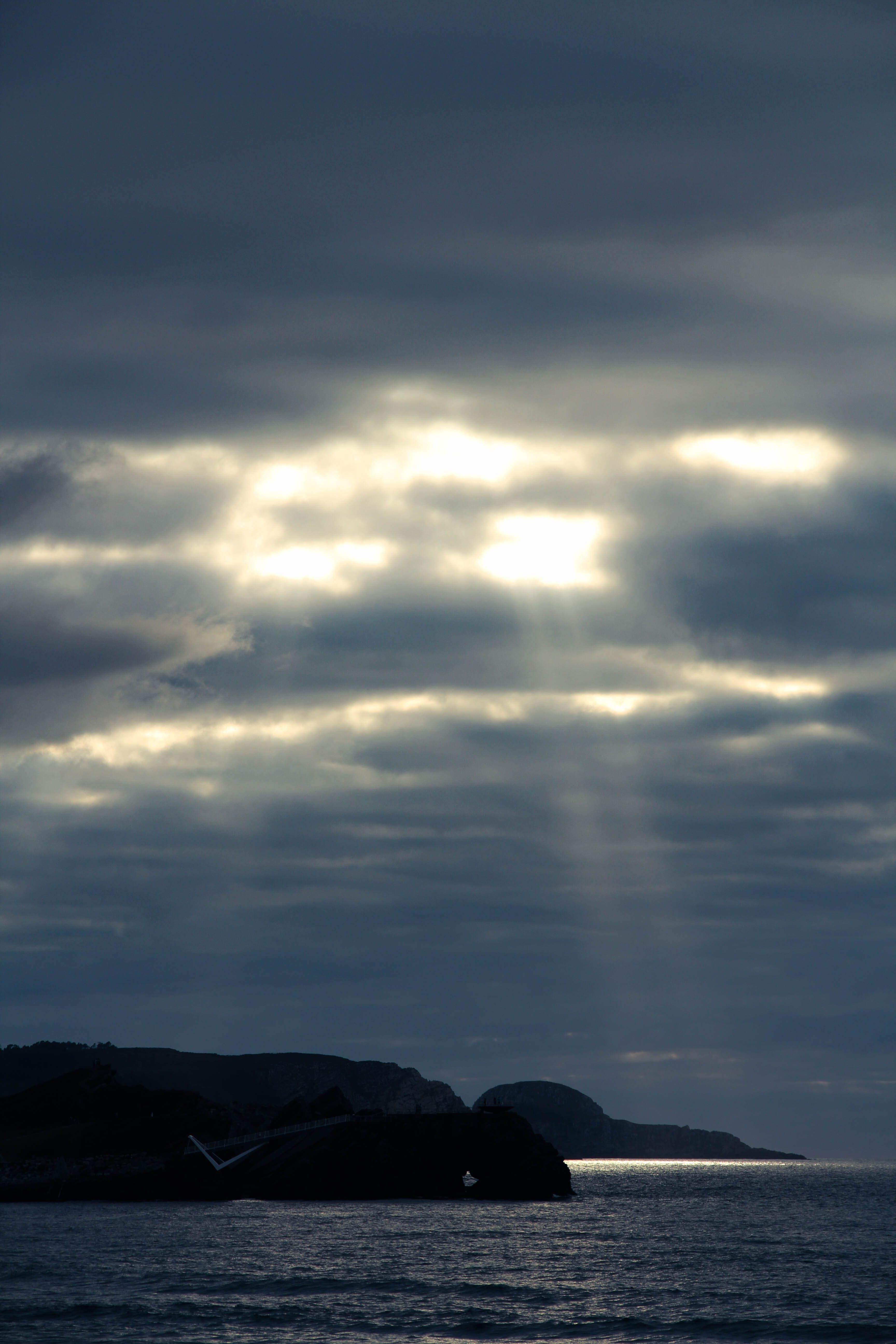 Sunbeams over Sea Coast under Cloud · Free Stock Photo