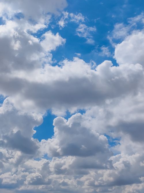Free Beautiful fluffy white clouds scattered across a clear blue sky. Stock Photo