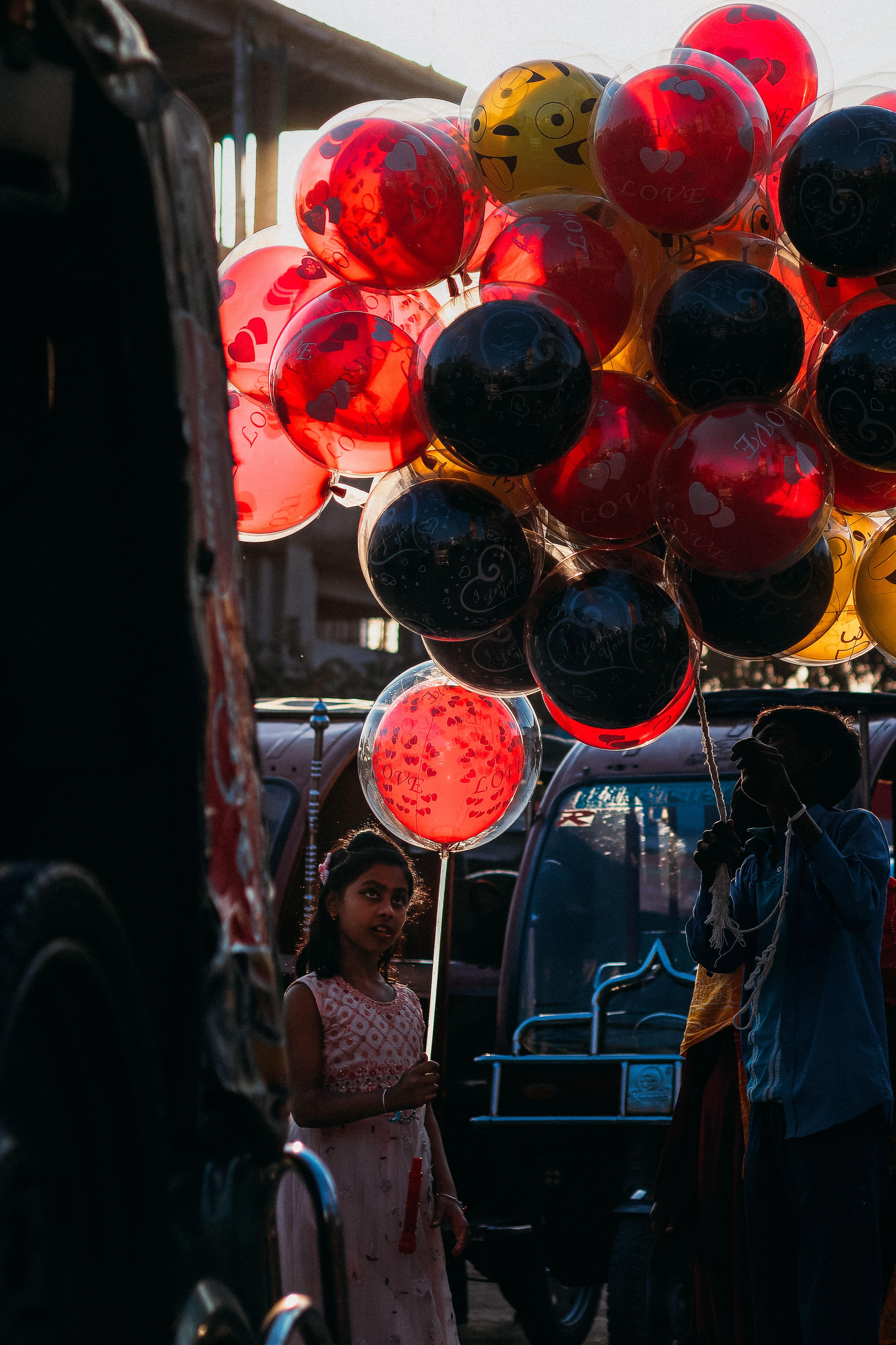 Girl Standing with Colorful Balloons on Street · Free Stock Photo