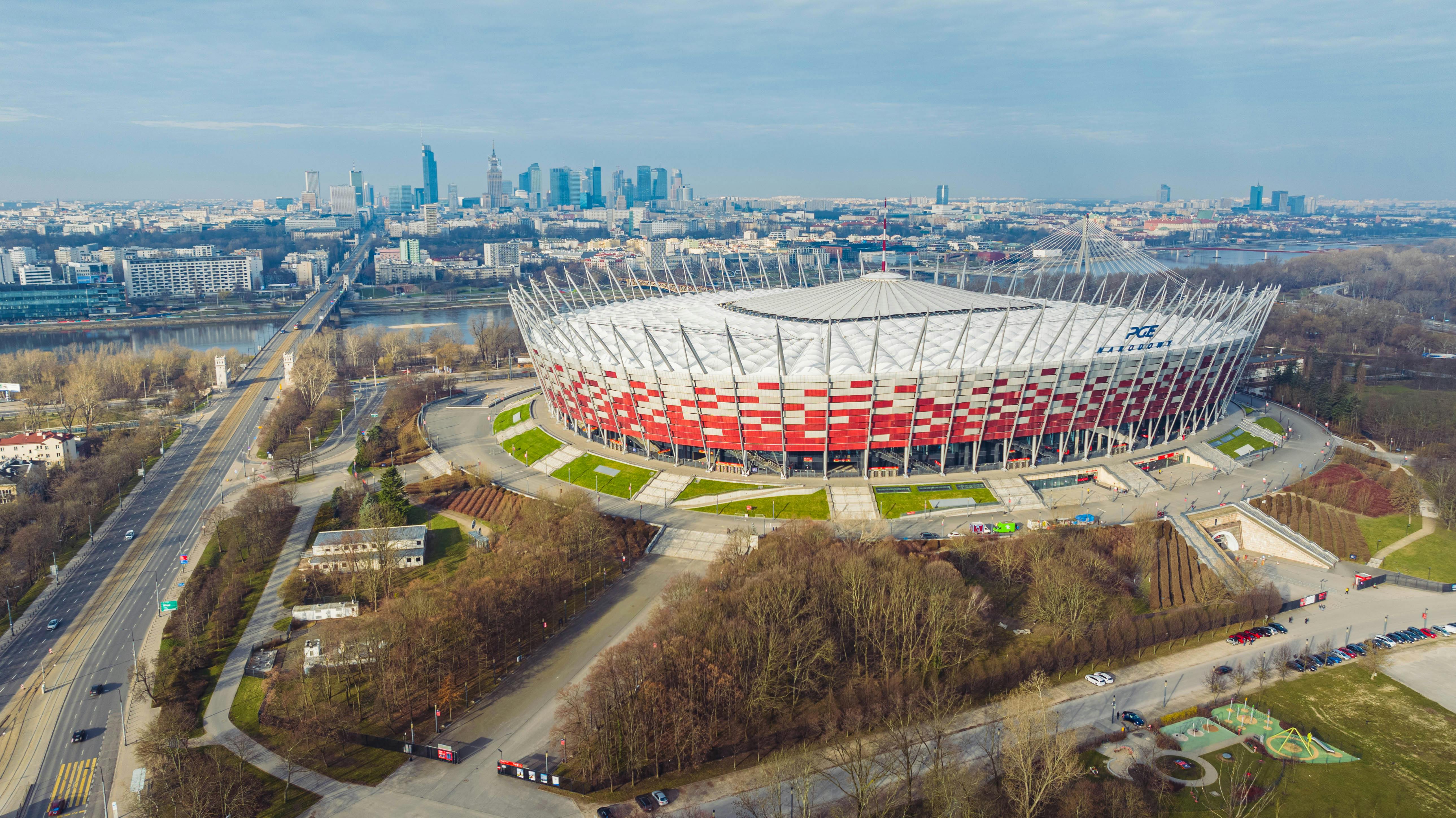 Aerial photo of the National Stadium in Warsaw, showcasing urban skyline.