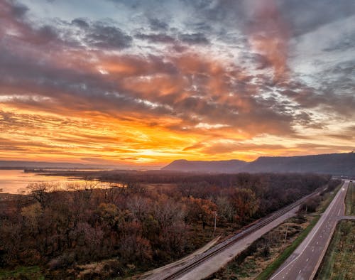 A sunset over a highway and river