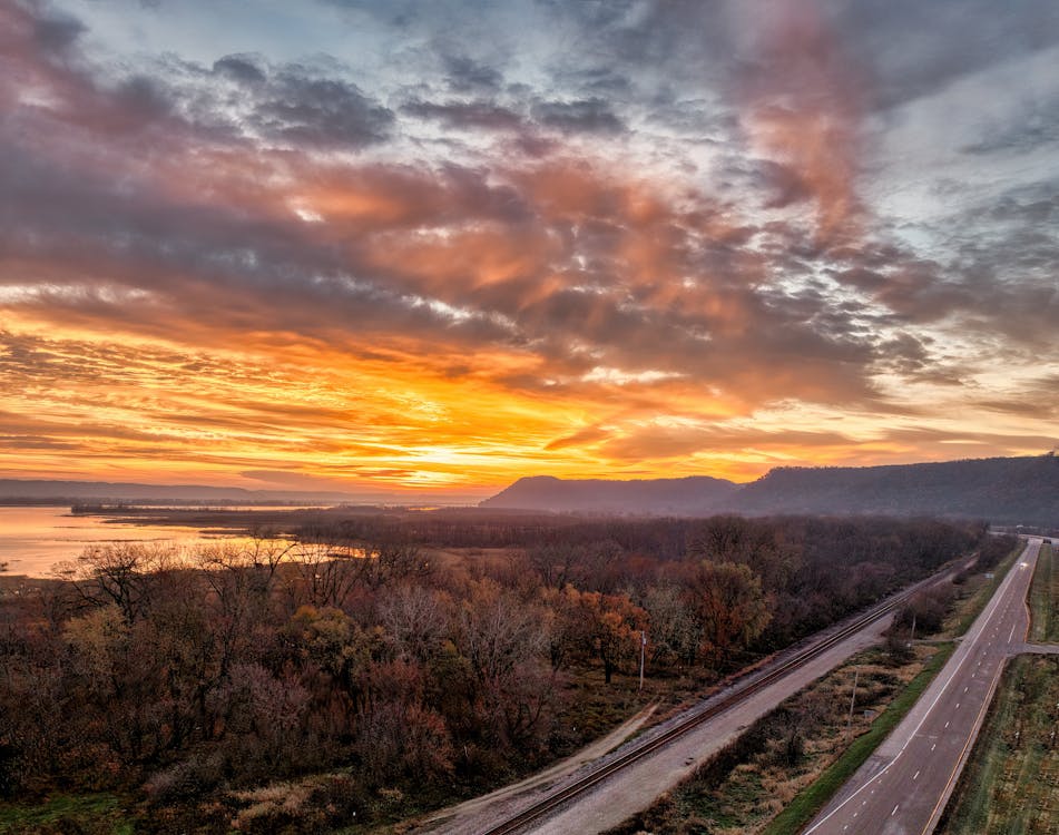 A sunset over a highway and river