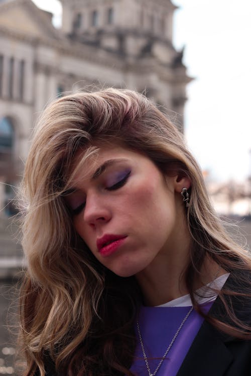 A woman with purple lipstick and purple eyes