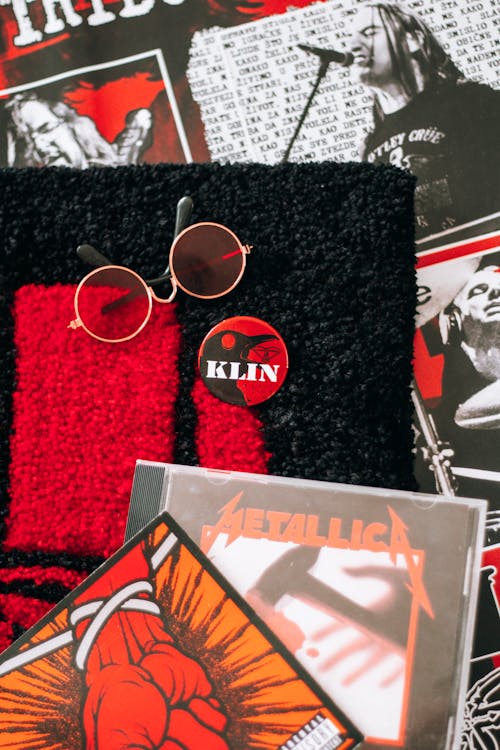 A red and black poster with a cd and sunglasses