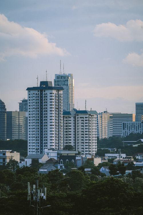 Free A serene view of Jakarta's urban skyline with tall buildings and green areas. Stock Photo