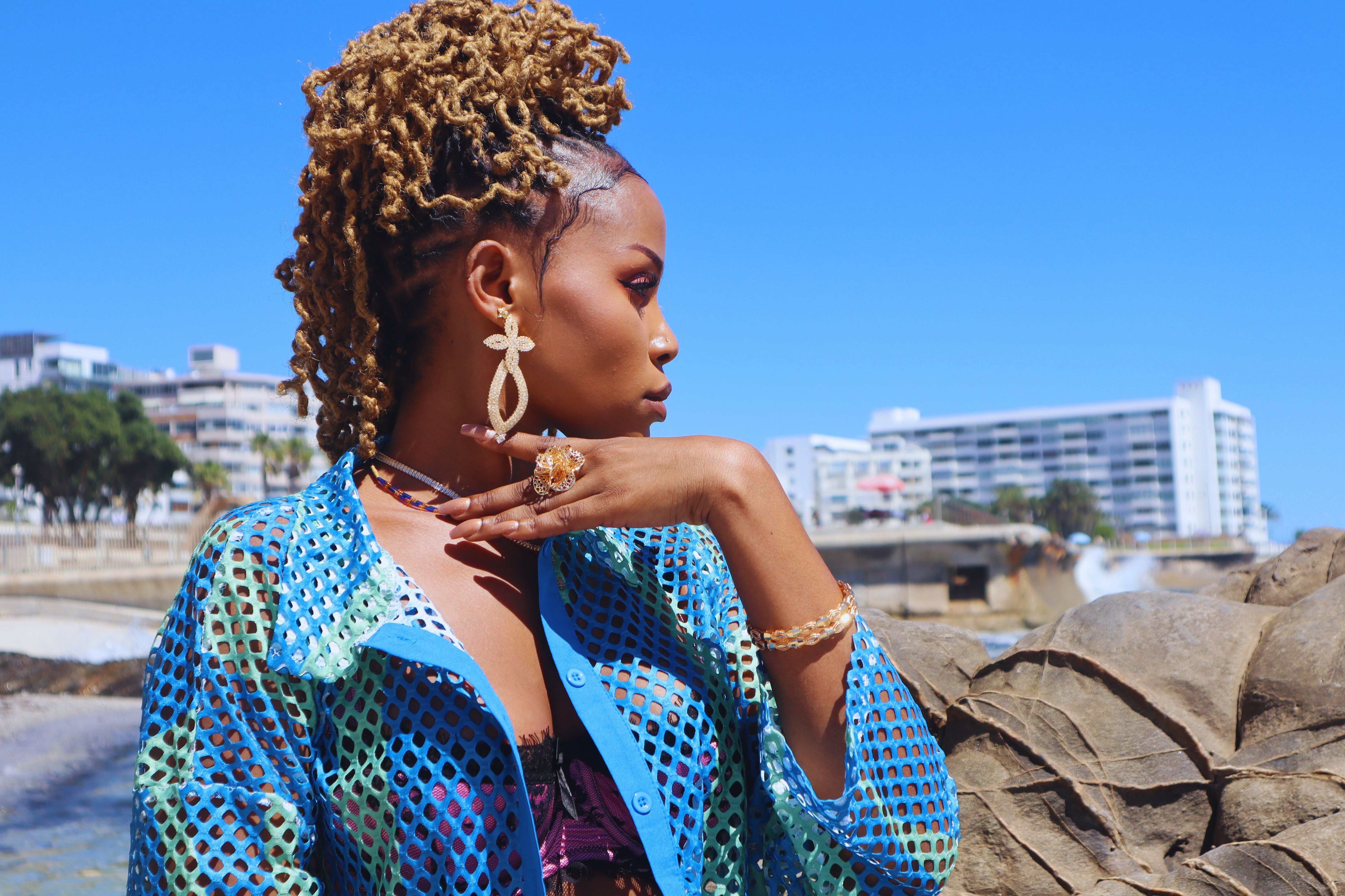 Side bust profile of fashionable african woman with locs showcasing ...