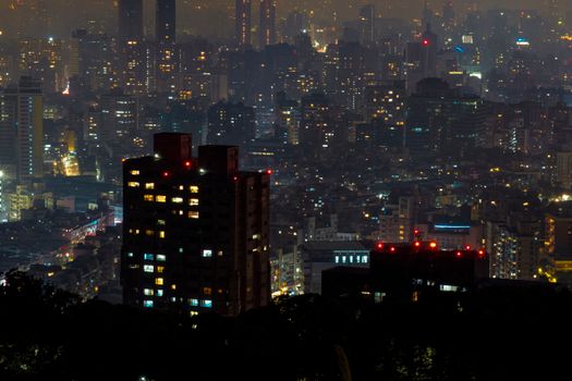 Stunning aerial shot capturing Taipei's city skyline illuminated at night.