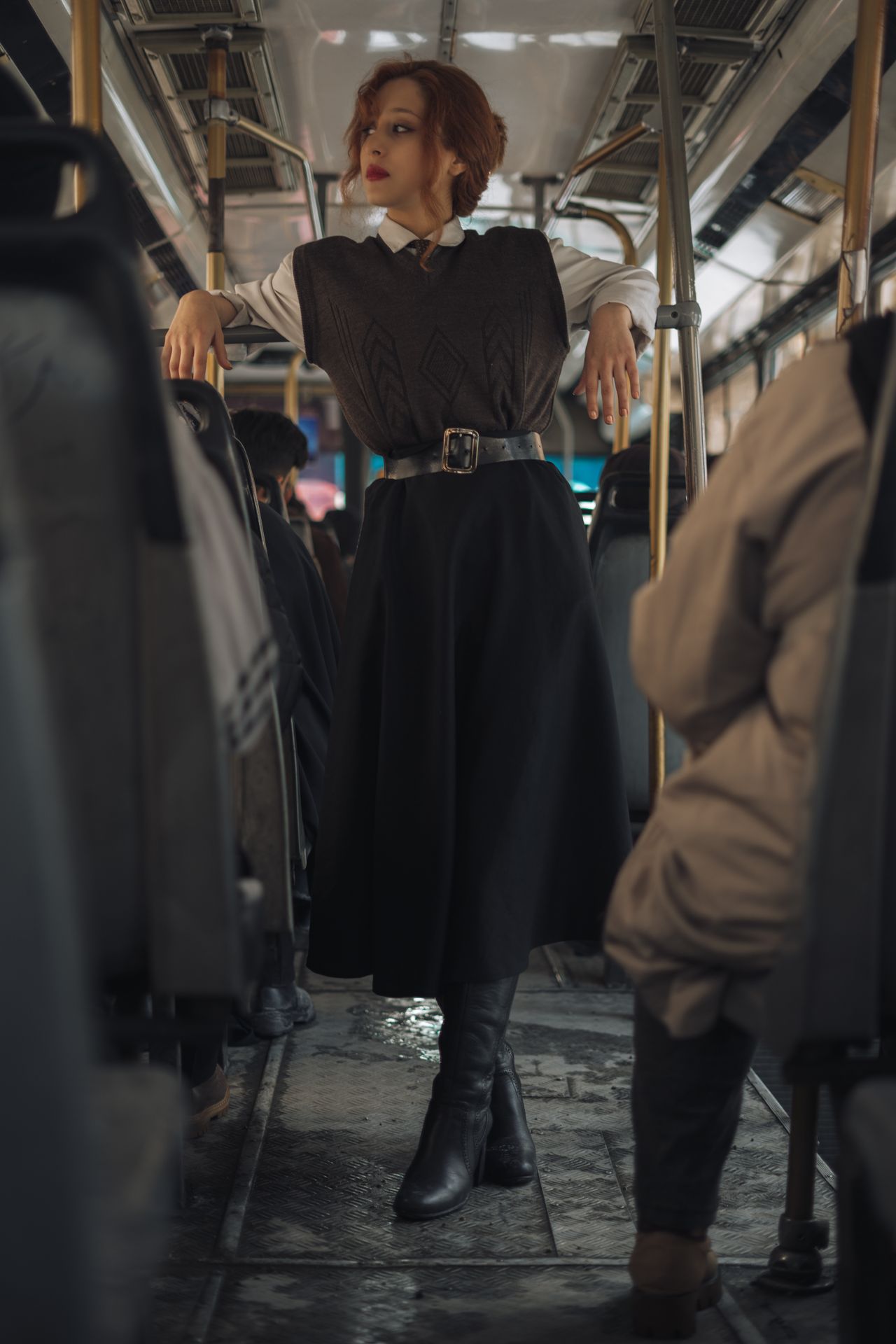 Woman in a vintage-inspired vest, shirt, midi skirt and boots