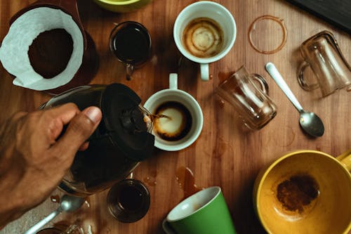 A person pouring coffee into a cup