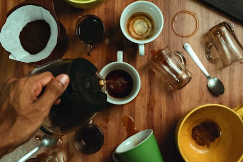 A person pouring coffee into a cup