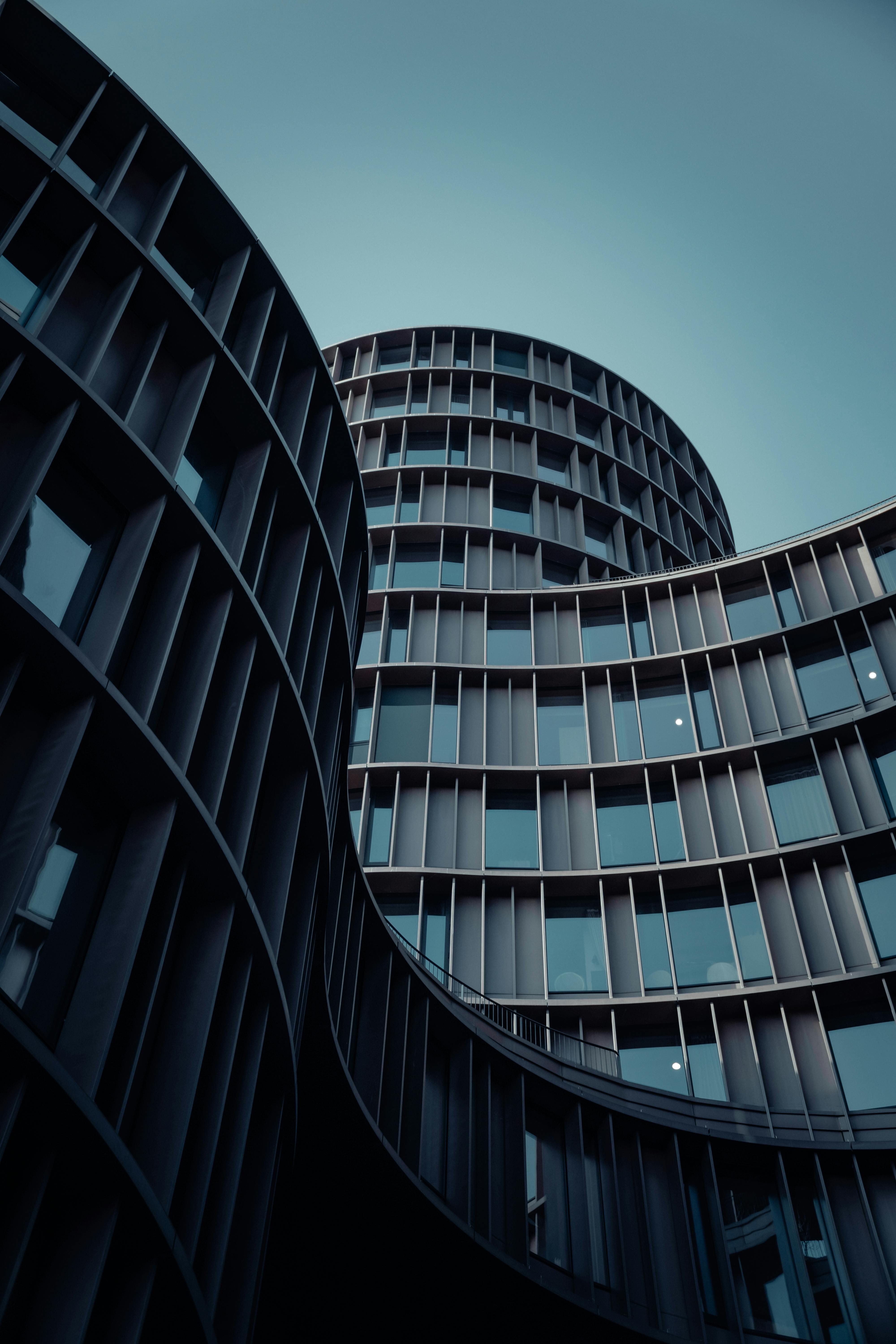 Low angle view of a modern curved skyscraper in Copenhagen, highlighting urban architectural design.
