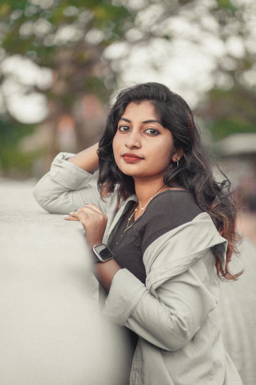 A young woman leaning against a wall