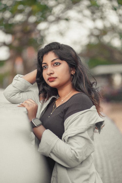 A young woman leaning against a wall