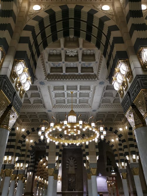 The interior of a mosque with a chandelier