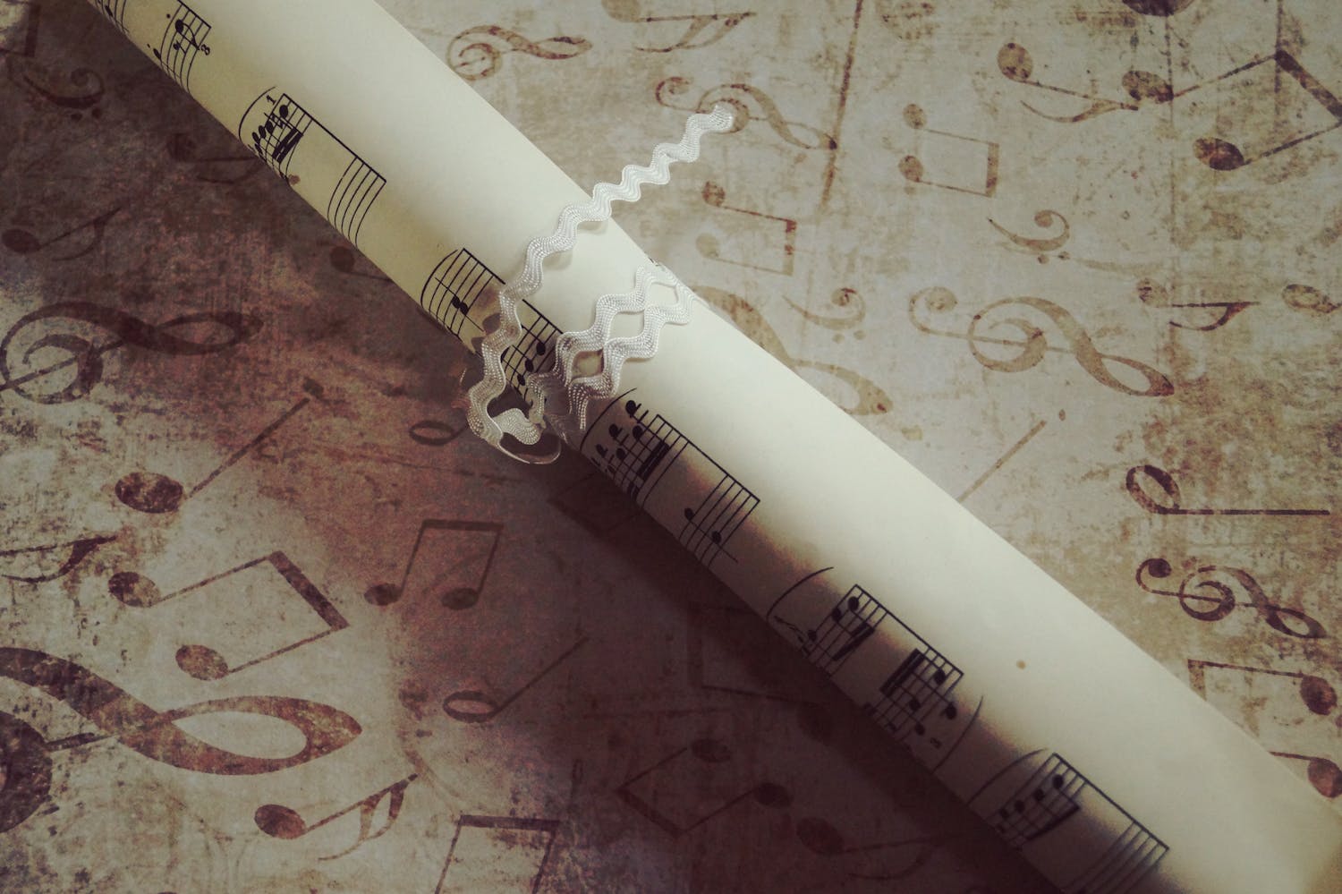 Rolled sheet music with notes