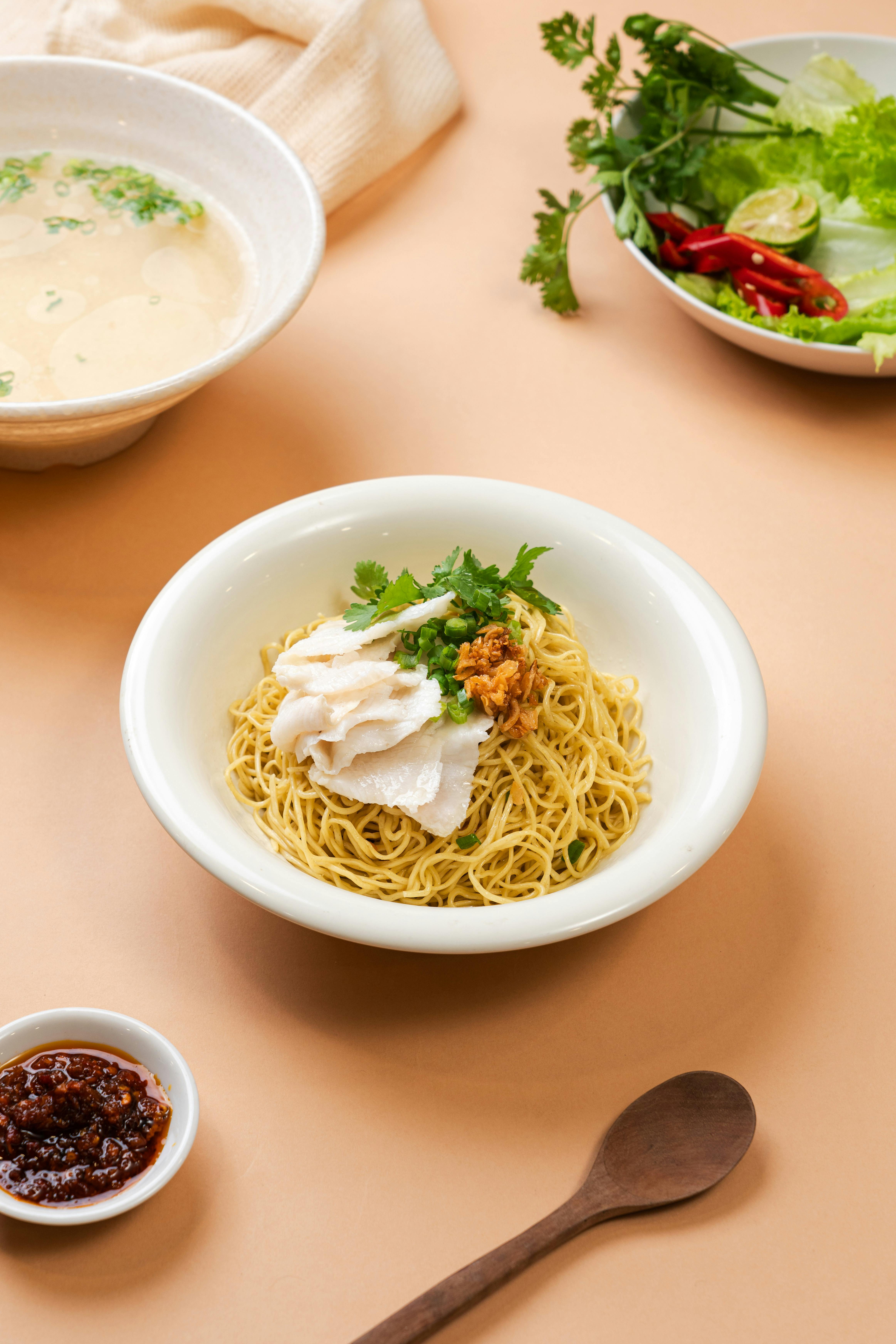 Top view of Vietnamese noodle dish served with fresh vegetables and soup in Ho Chi Minh City.