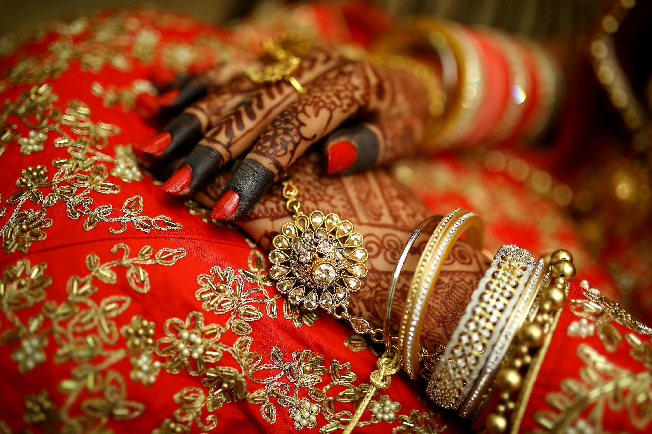an Indian bride with mehendi clad hands