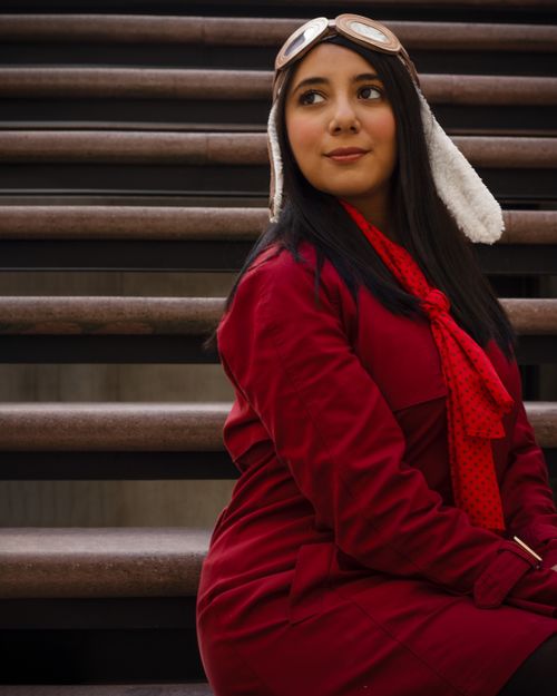 Free Fashionable woman in red outfit posing on stairs in Mexico City. Stock Photo