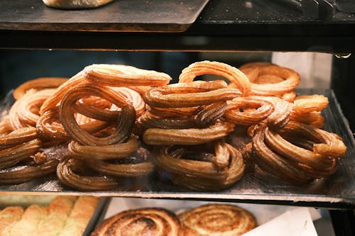 A tray of churros in a bakery