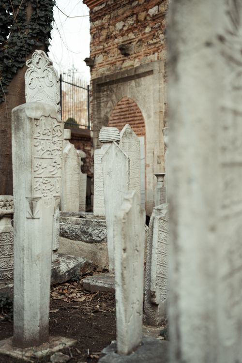 Free A serene view of an old cemetery with intricately carved tombstones and historic architecture. Stock Photo
