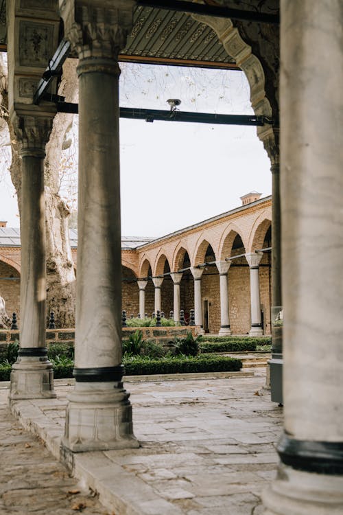 The courtyard of a building with pillars and arches