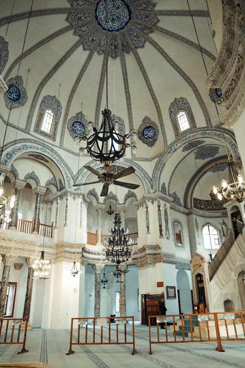 The interior of a mosque with a chandelier