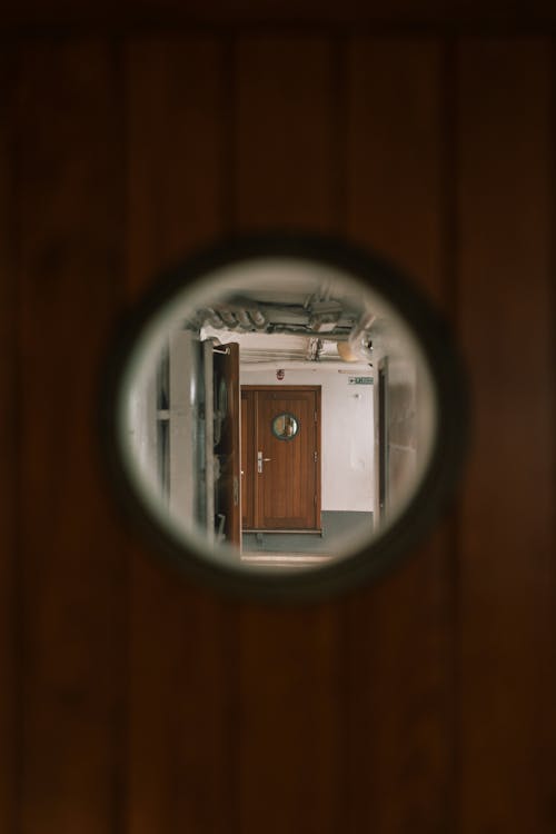 A view of a door through a round hole