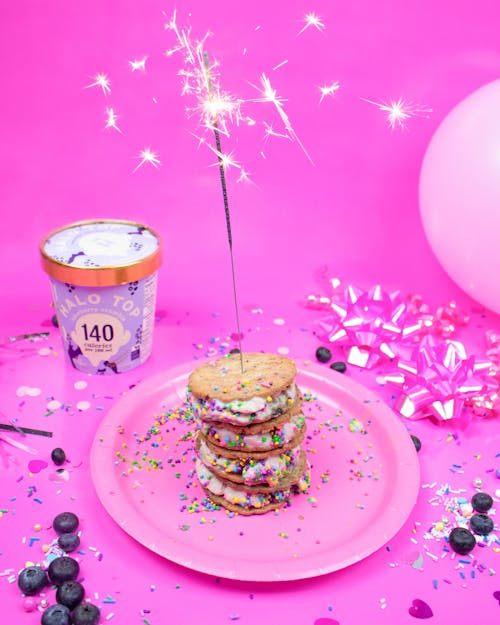 Free Stacked of Cookies with Cream Filling topped with a Sparkler  Stock Photo