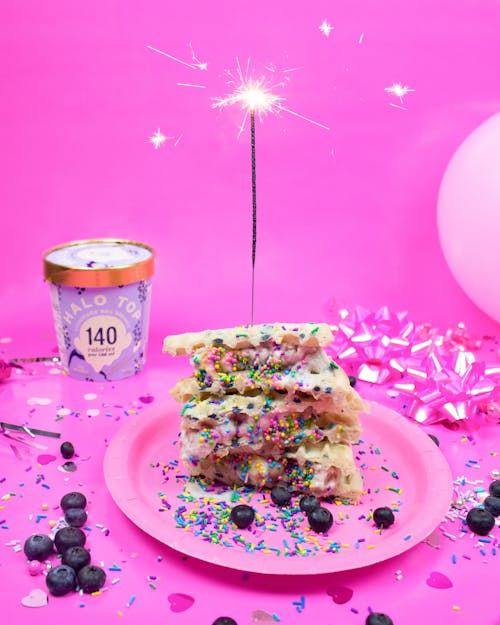 Dessert with Sparkler on a Pink Plastic Plate