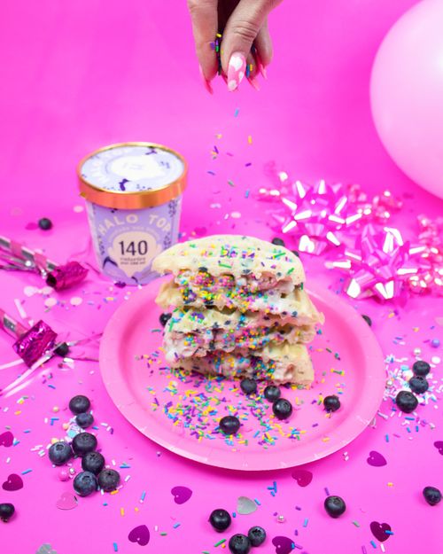 Free Bright and colorful funfetti waffles topped with blueberries and sprinkles, set against festive party decor. Stock Photo