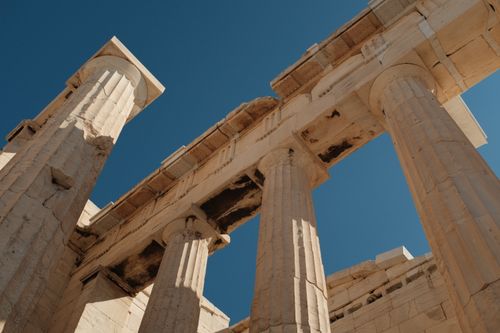 Free Elegant ancient Greek columns of the Parthenon in Athens, Greece against a vivid blue sky. Stock Photo