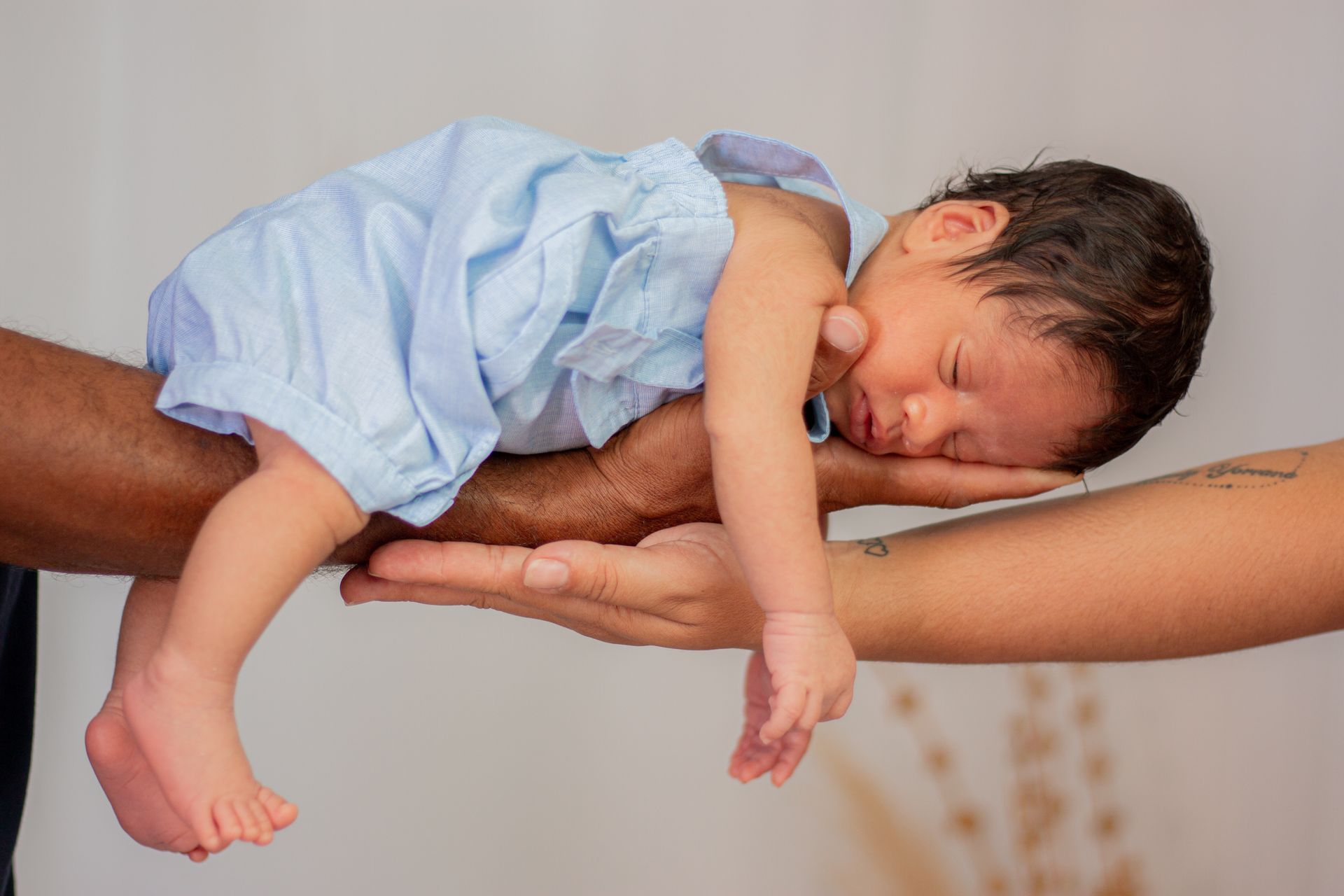 Baby on Hands of Parents