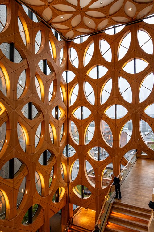 Building Inside Building The inside of a building with a large wooden structure · Free Stock Photo
