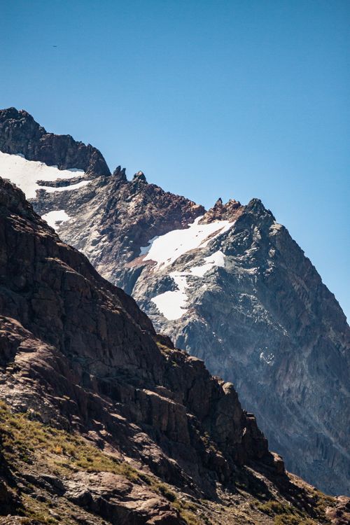 Free Spectacular view of snow-capped mountains against a blue sky, showcasing natural beauty. Stock Photo