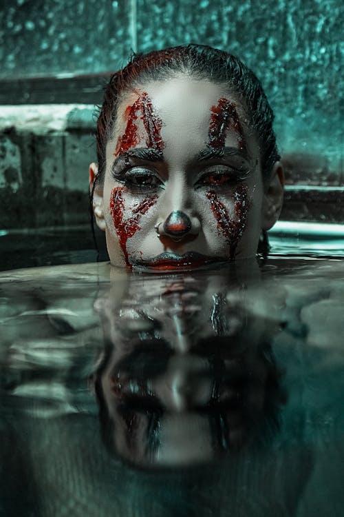 Woman with Halloween Makeup on Face in Water