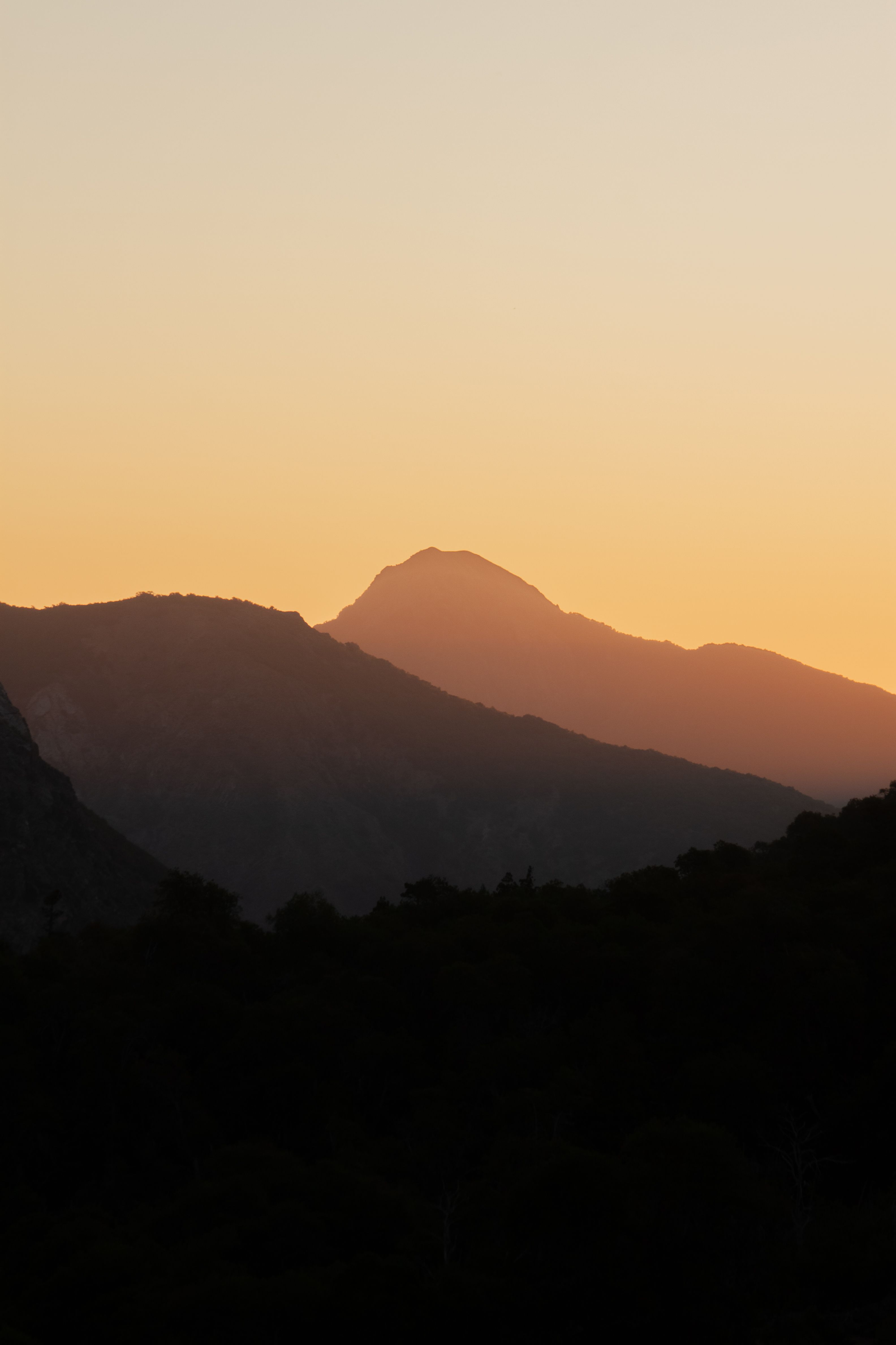 Amber sunset over a mountain silhouette, photo by Oscar Sanchez on Pexels