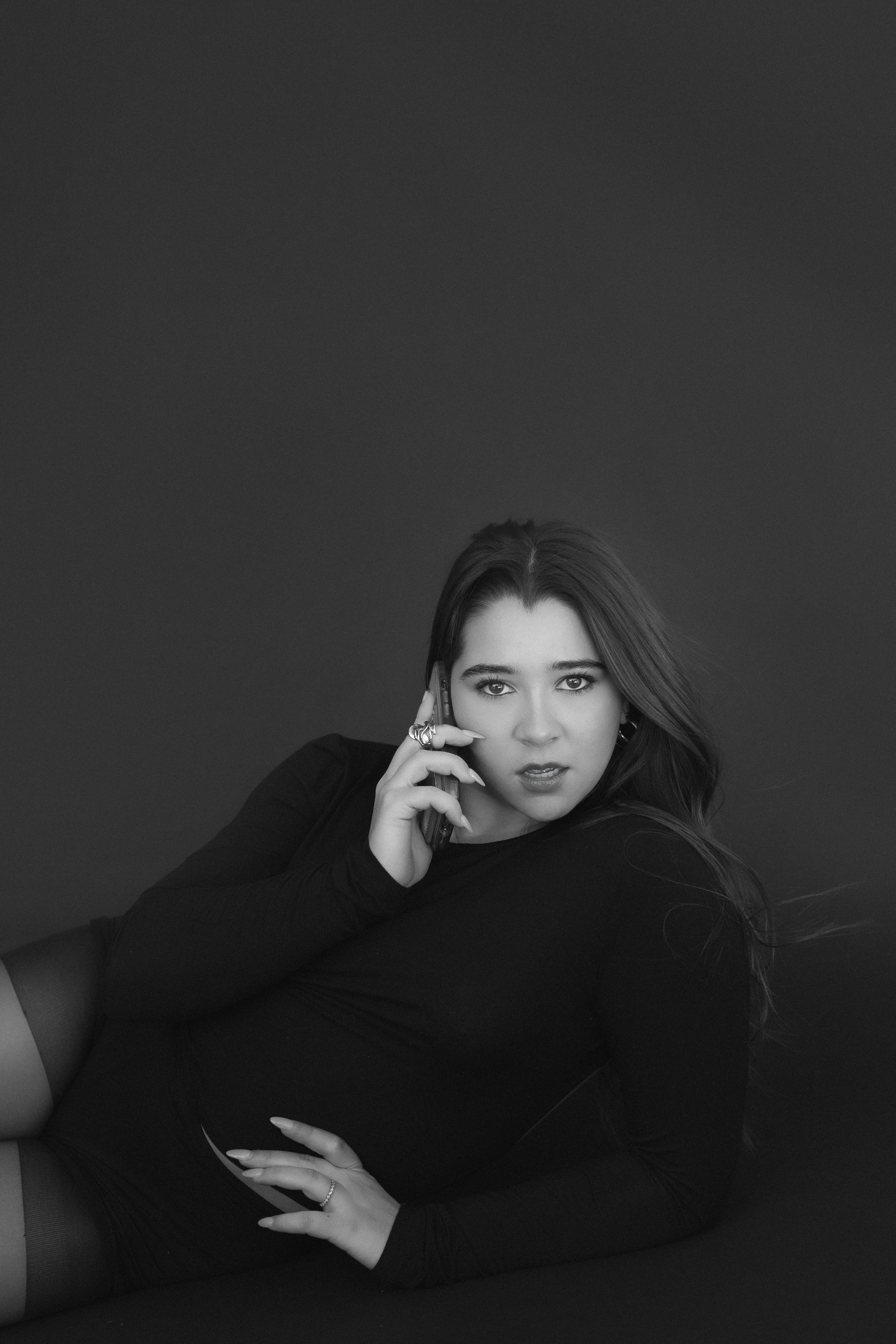 Beautiful Woman Posing with Phone in Hand in Studio · Free Stock Photo